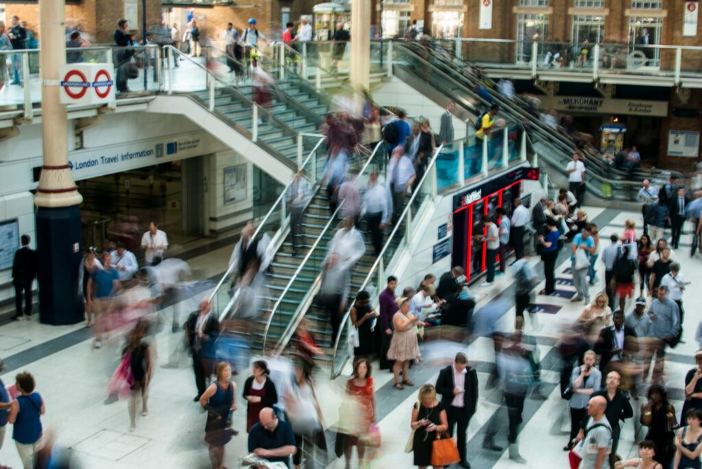 Busy, blurred train station photo. The antidote to digital overwhelm is a repivot mindset.