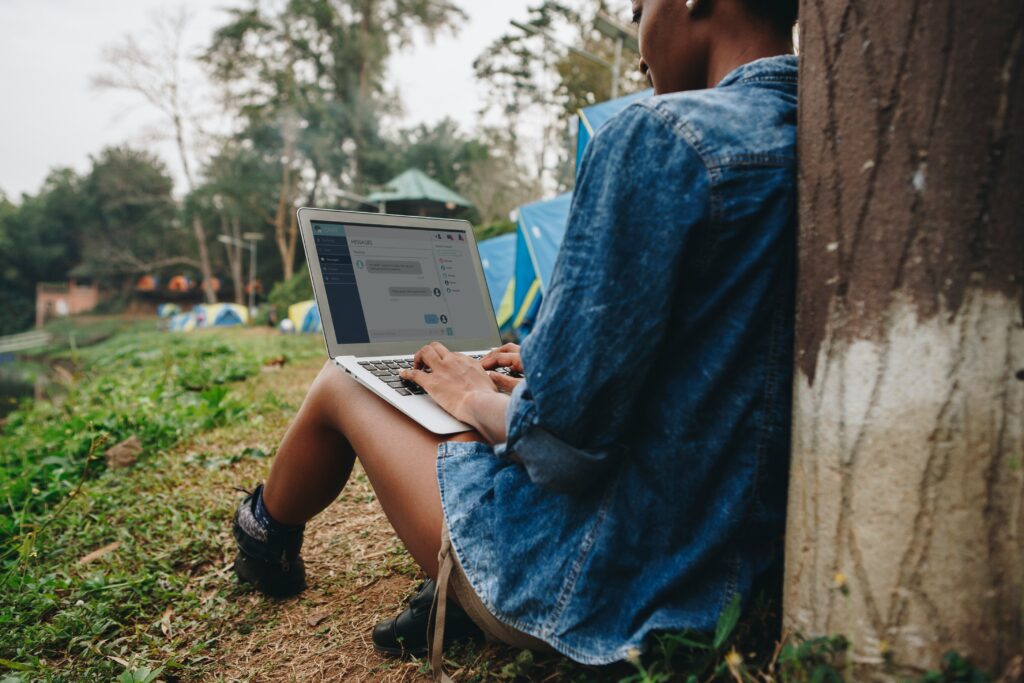 Working outside on computer. A repivot mindset is key to reducing digital overwhelm.