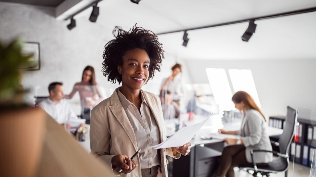 Professional demonstrating repivot workforce transformation with confident smile, ready to lead in the AI-driven workplace.