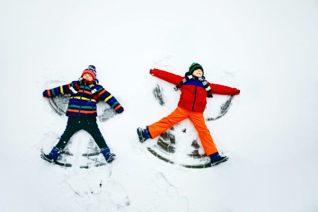 Children play in the snow. Join them and reduce digital overwhelm.