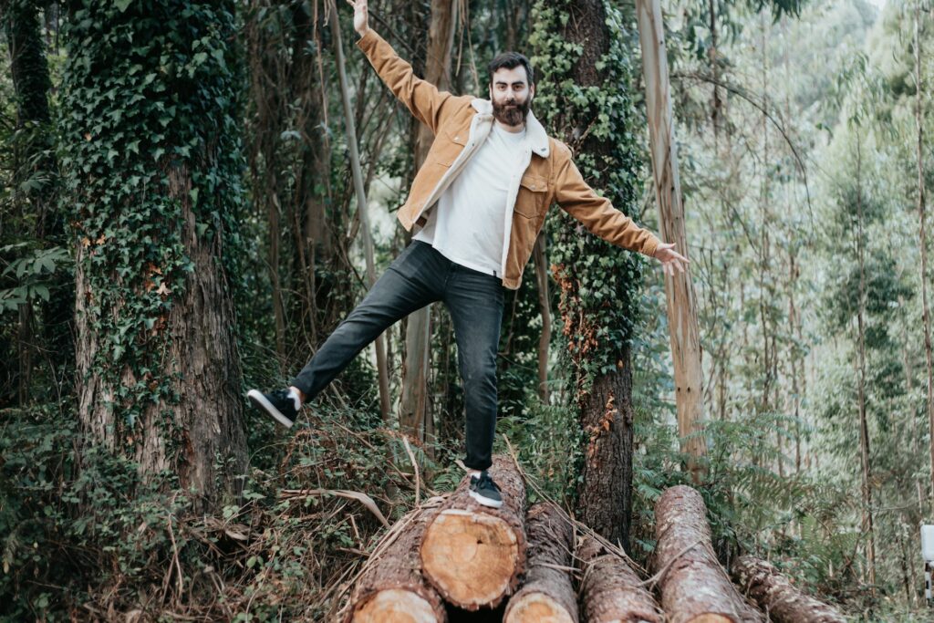 Photo of man balancing on a log. Maintaining balance is one of the most effective leadership strategies.
