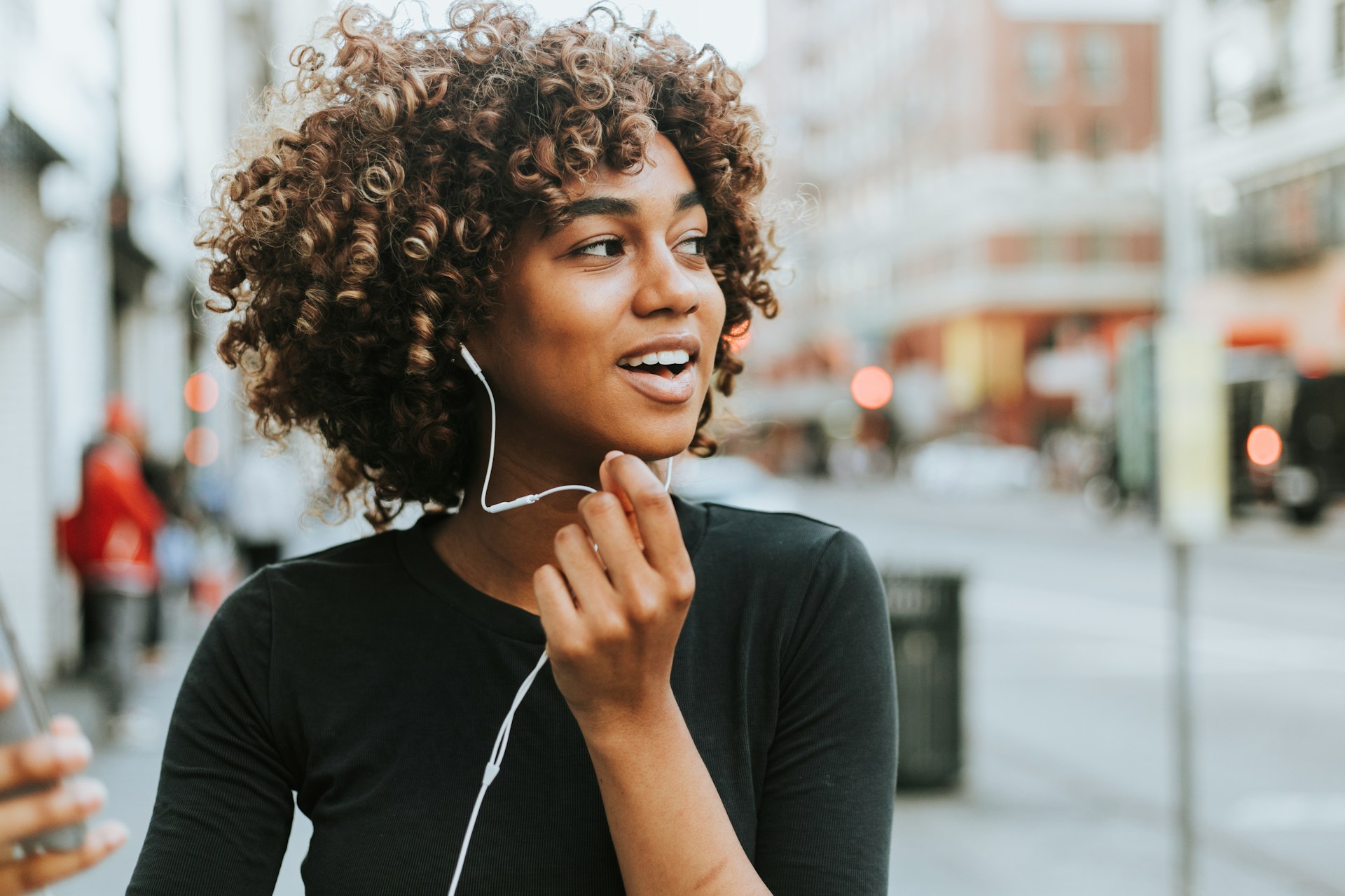 Woman listening to headphones using learn faster strategies