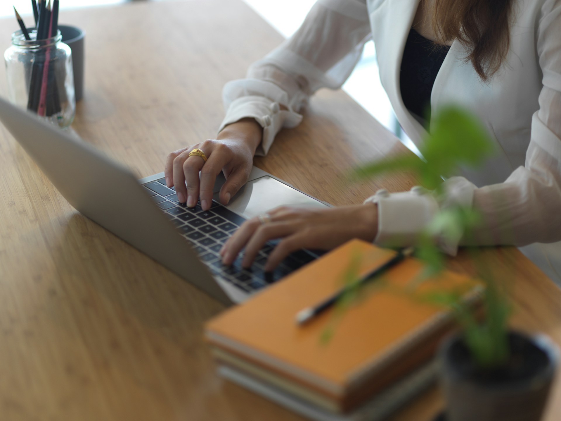 Continuous learning is one of the most important strategic thinking techniques. Woman typing at computer.